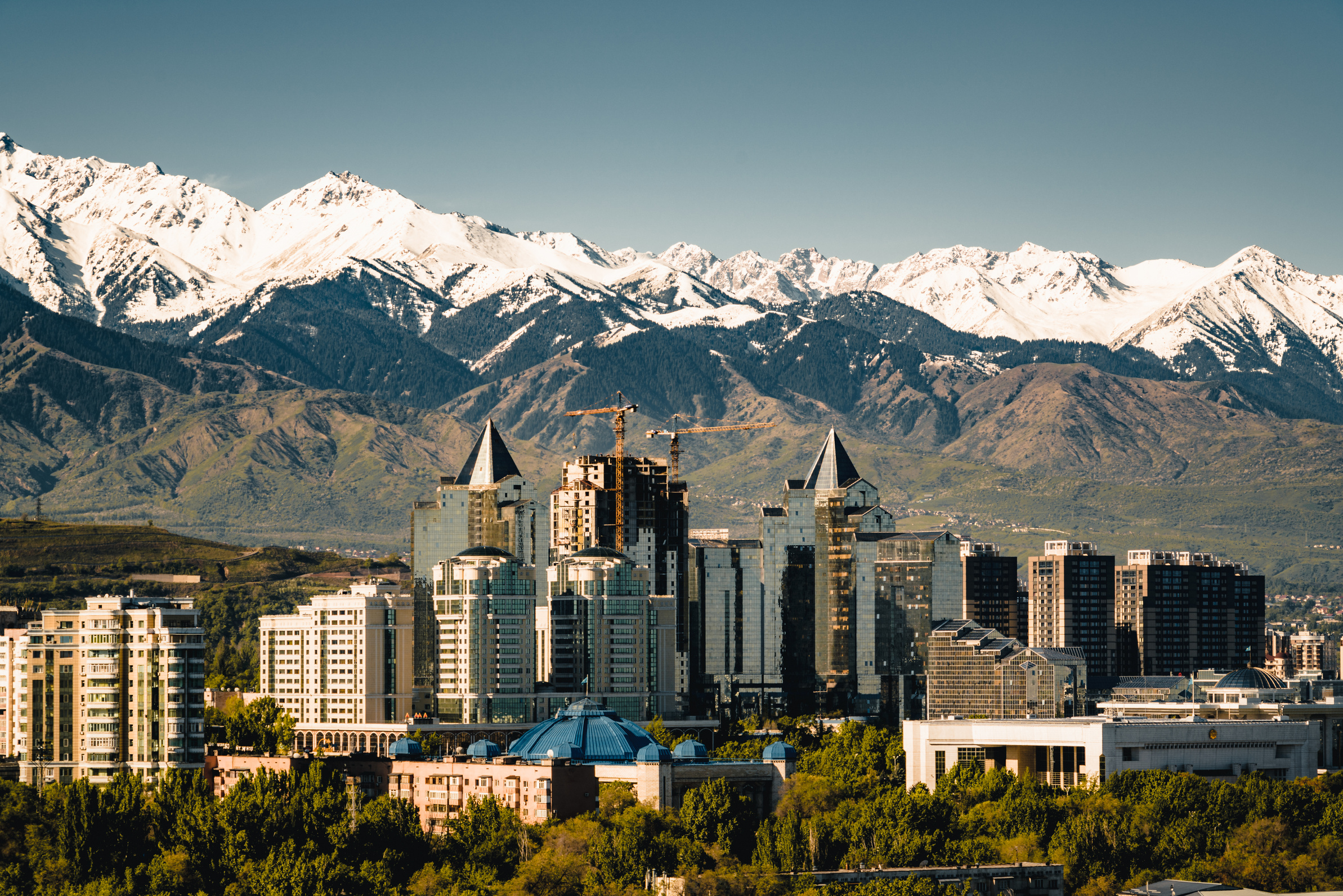 City landscape on a background of snow-capped Tian Shan mountains in Almaty Kazakhstan